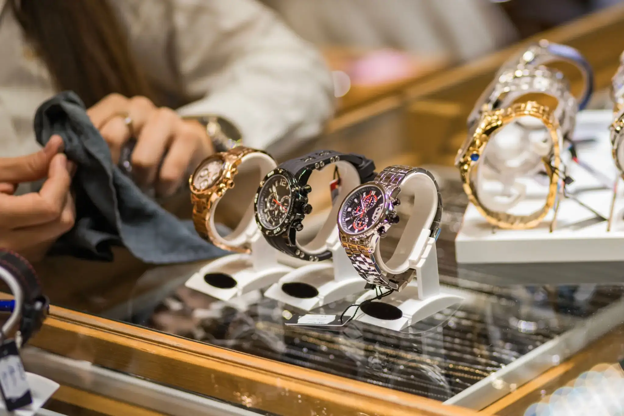 Luxury watches displayed on stands in a store.