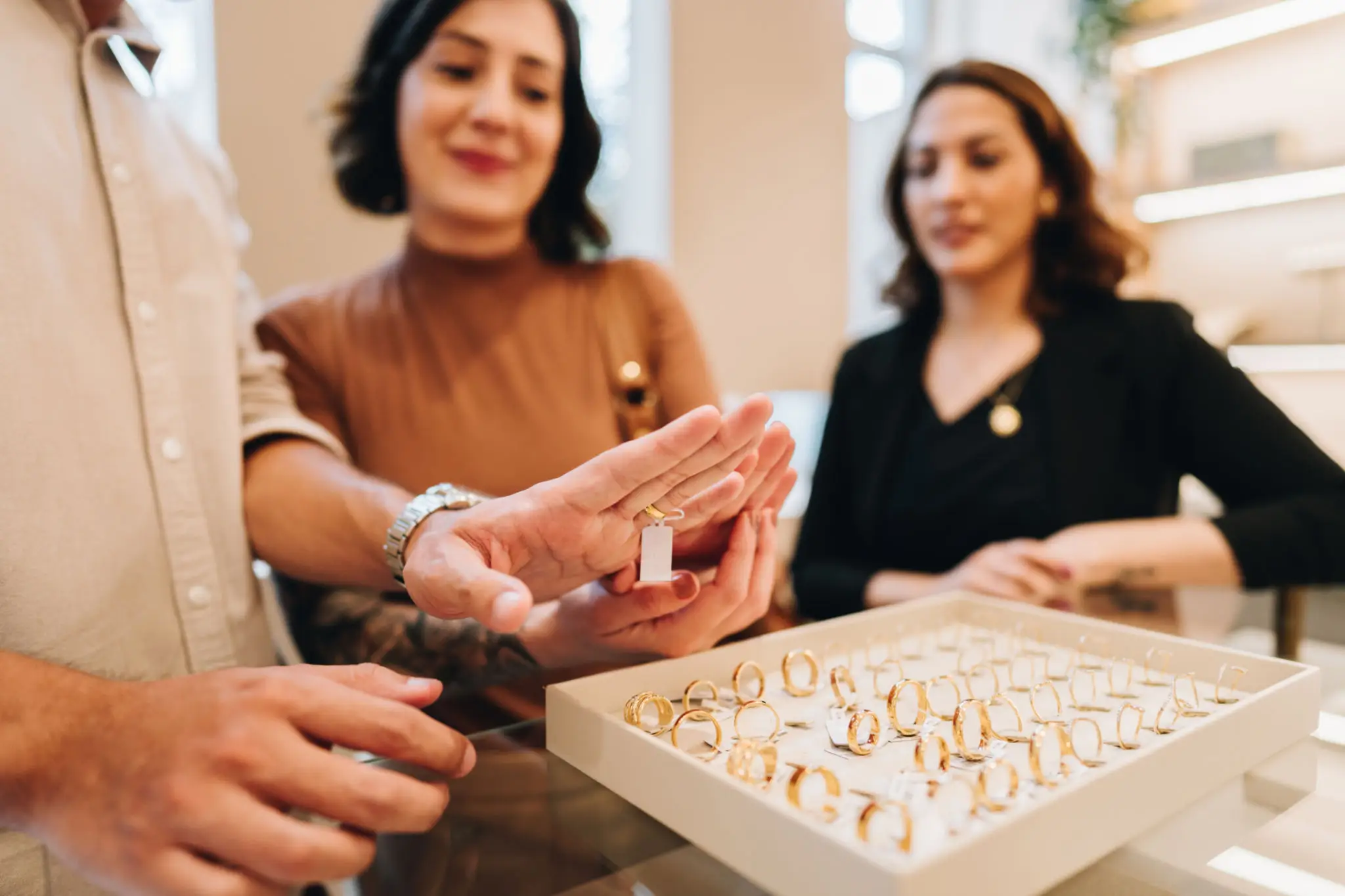 Two women examining rings at a jewelry store.